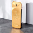 Gold bottle of Paco Rabanne 1 Million perfume on a gray surface with a white background. Perfume