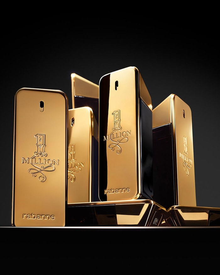 Gold perfume bottles with '1 Million' branding on a black background