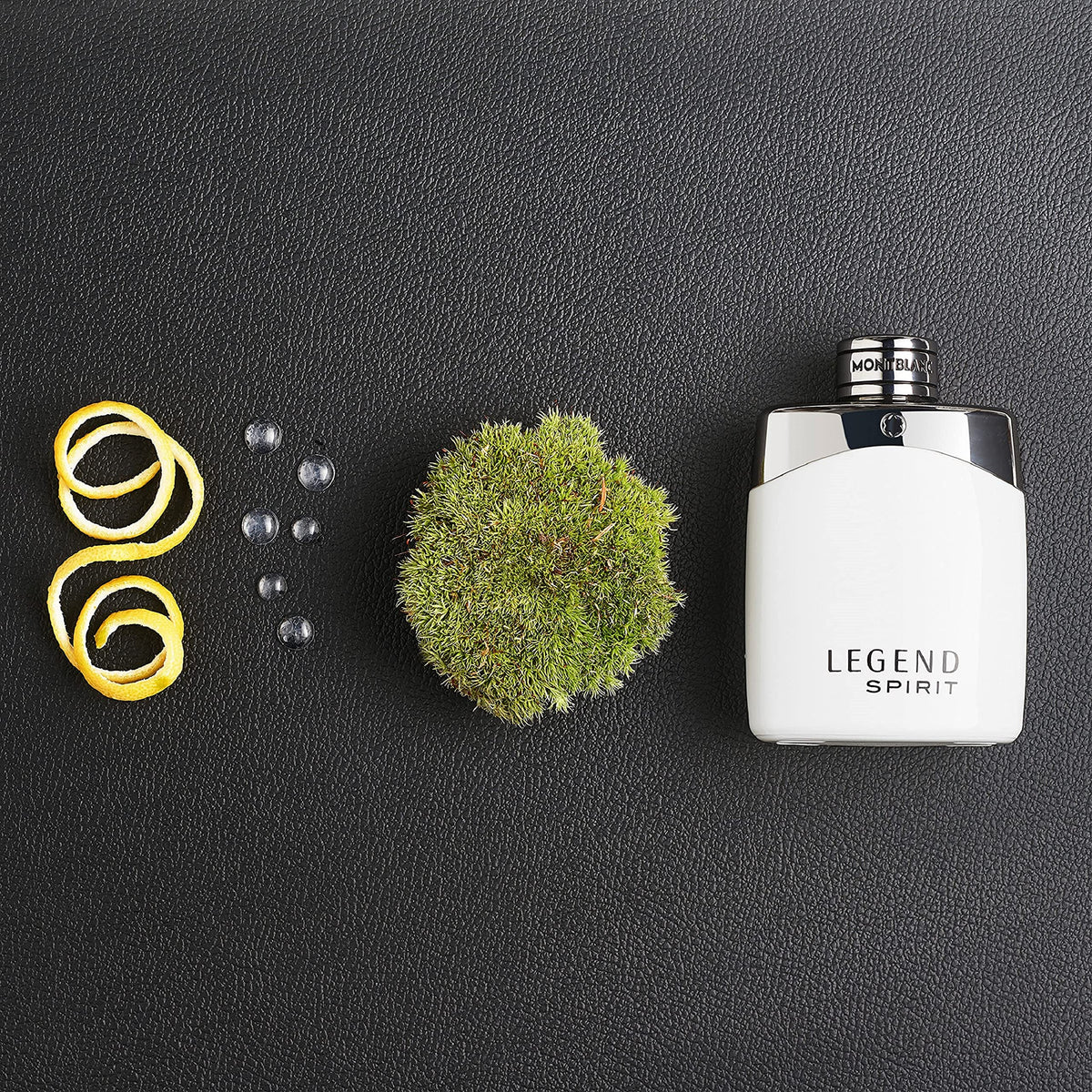 Perfume bottle labeled 'Legend Spirit' with decorative elements on a dark surface