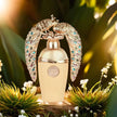 Decorative perfume bottle with peacock design on a natural background