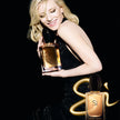 Woman holding a perfume bottle with 'Si' branding on a black background