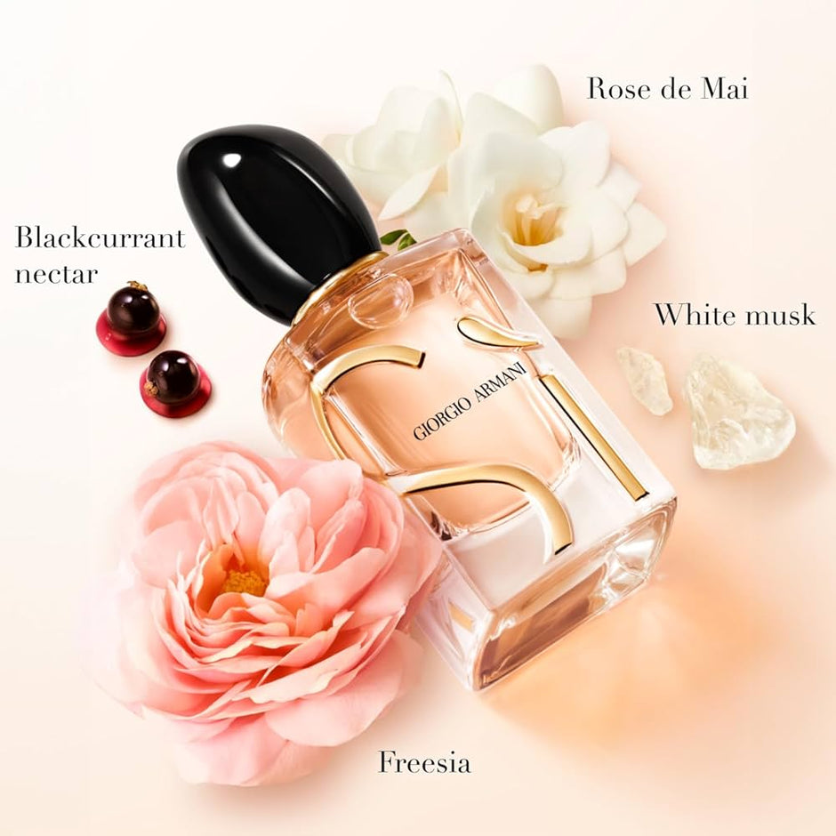 Giorgio Armani perfume bottle with flowers and berries on a light background