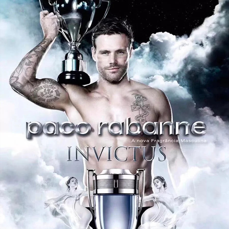 Advertisement for Paco Rabanne Invictus featuring a shirtless man holding a trophy against a cloud background. Perfume