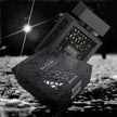 Black and white image of 'NOW' product packaging on a textured surface with a bright light source.