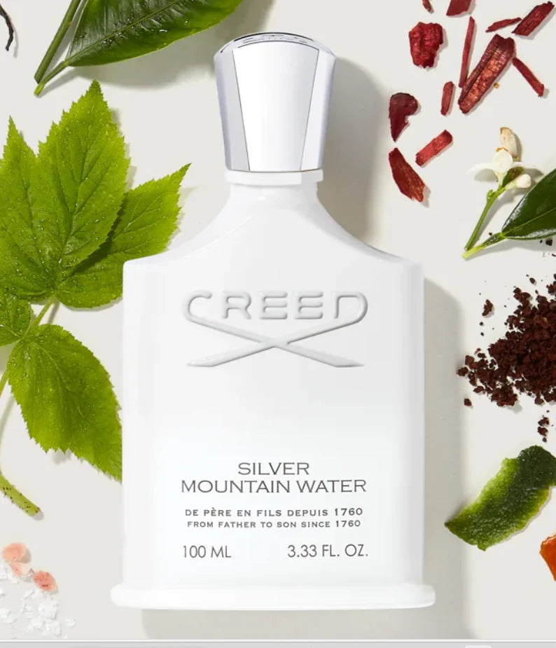 Creed Silver Mountain Water eau de parfum bottle with natural elements on a light background