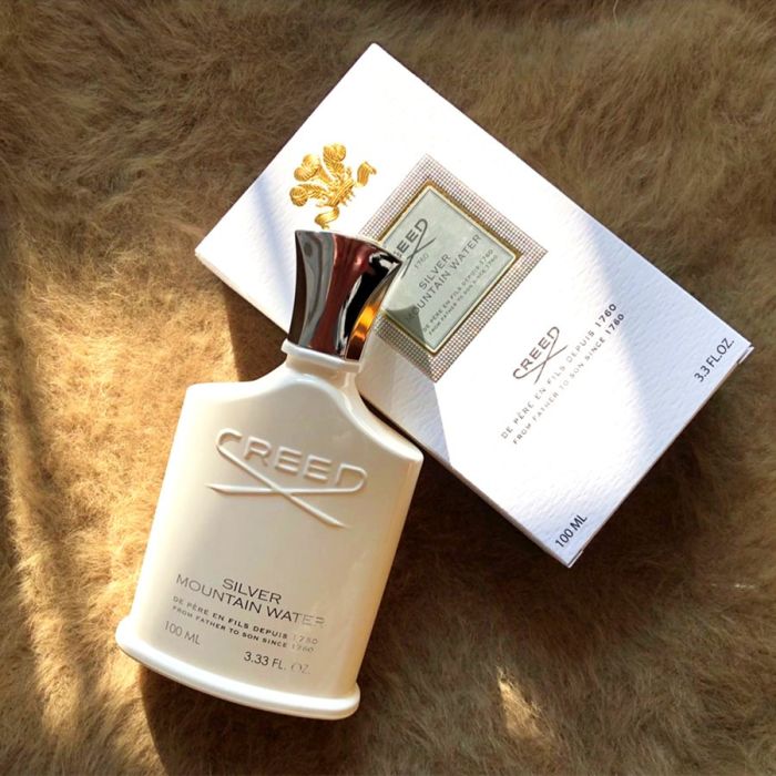 Creed Silver Mountain Waters perfume bottle and packaging on a fur surface
