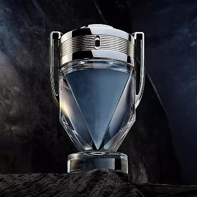 Glass perfume bottle with metallic cap on a dark background