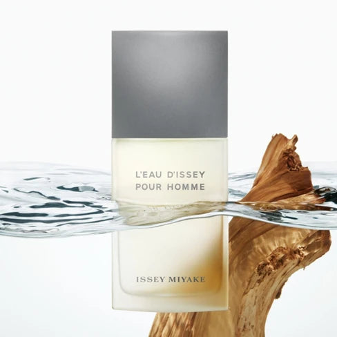 Issey Miyake L'EAU D'ISSEY POUR HOMME perfume bottle with water and wood elements on a white background