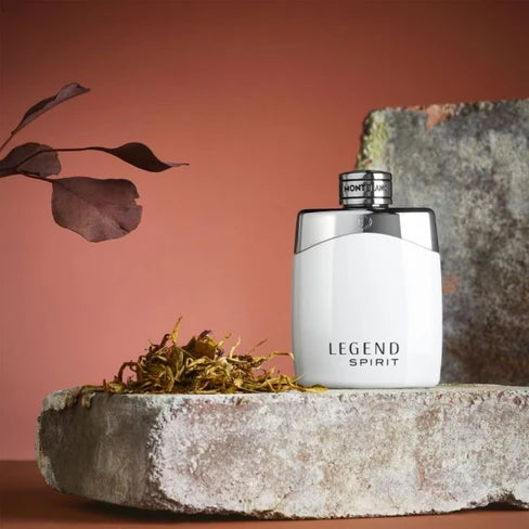 White 'Legend Spirit' perfume bottle on a stone surface with a natural background