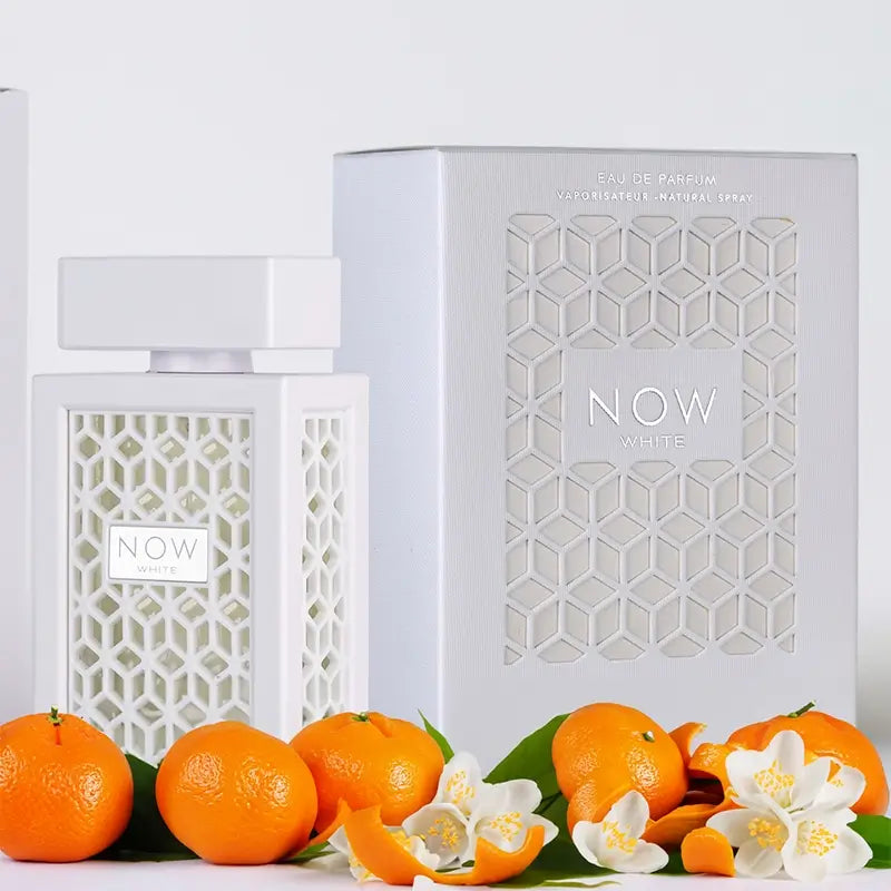 White perfume bottle and packaging with mandarin oranges and flowers on a white background