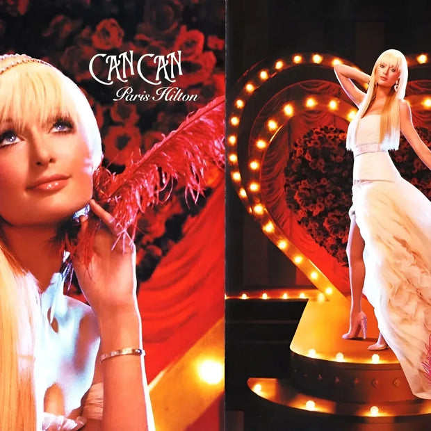 Promotional image of a woman in a white dress with 'Can Can' and 'Paris Hilton' text.