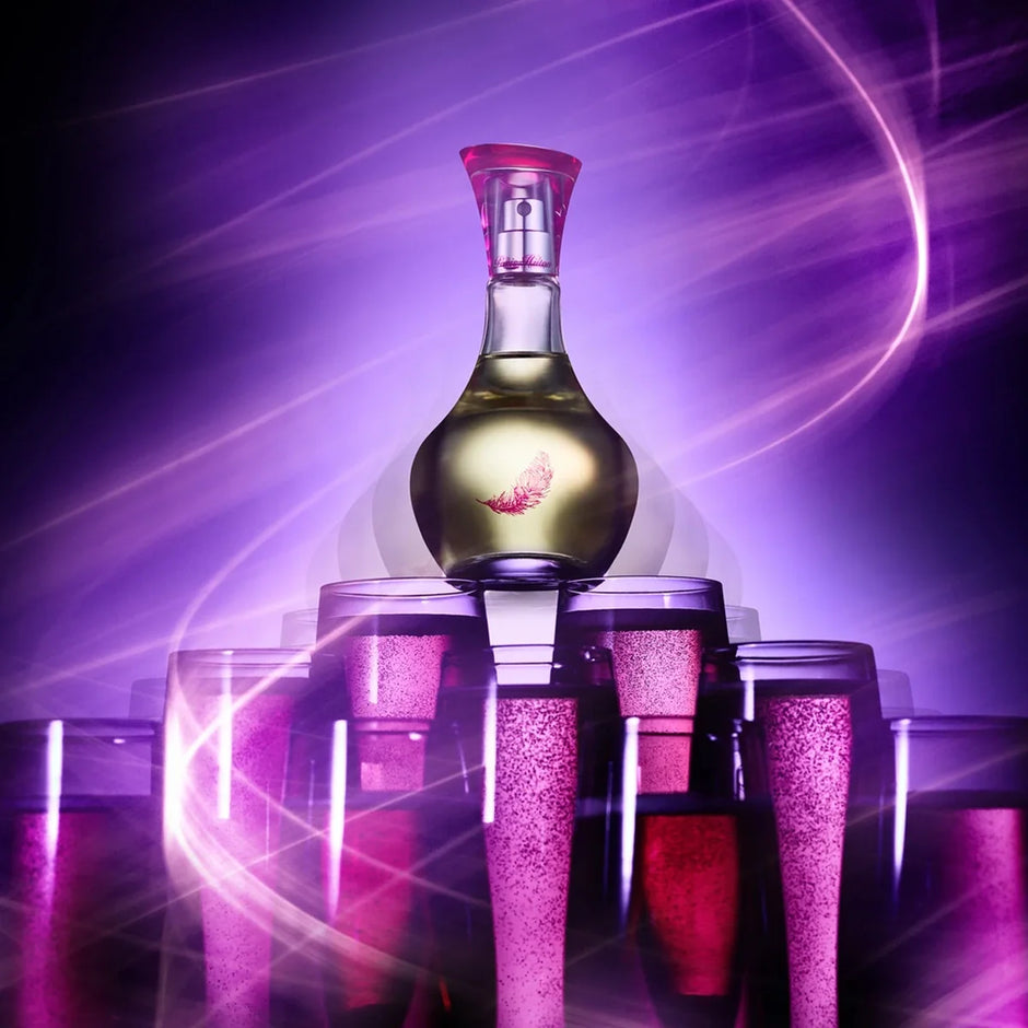 Bottle of alcohol with pink cap surrounded by pink glasses on a purple background