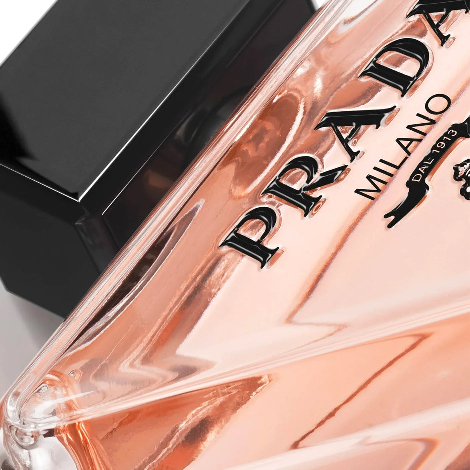 Close-up of a Prada perfume bottle with a clear cap.