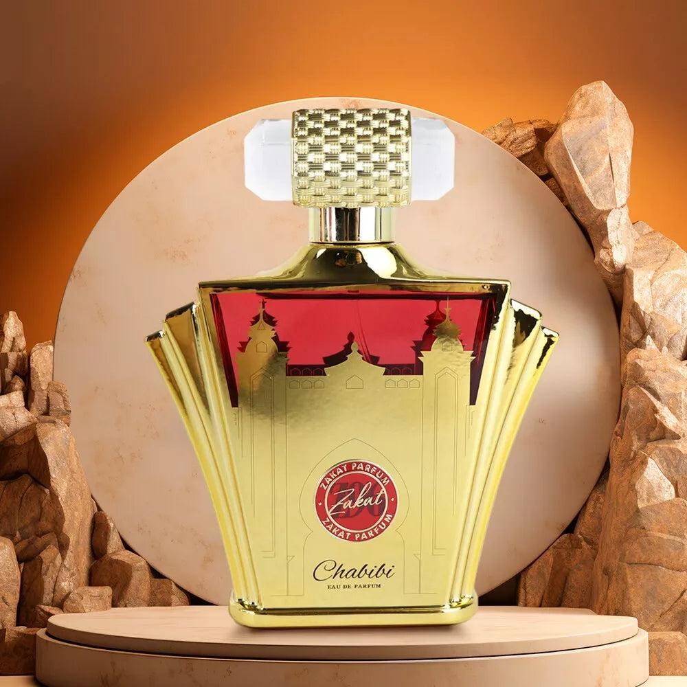 Gold and red perfume bottle with 'Zahab' branding on a stone background. Perfume