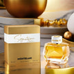 Montblanc perfume bottle and packaging on a reflective surface with decorative background