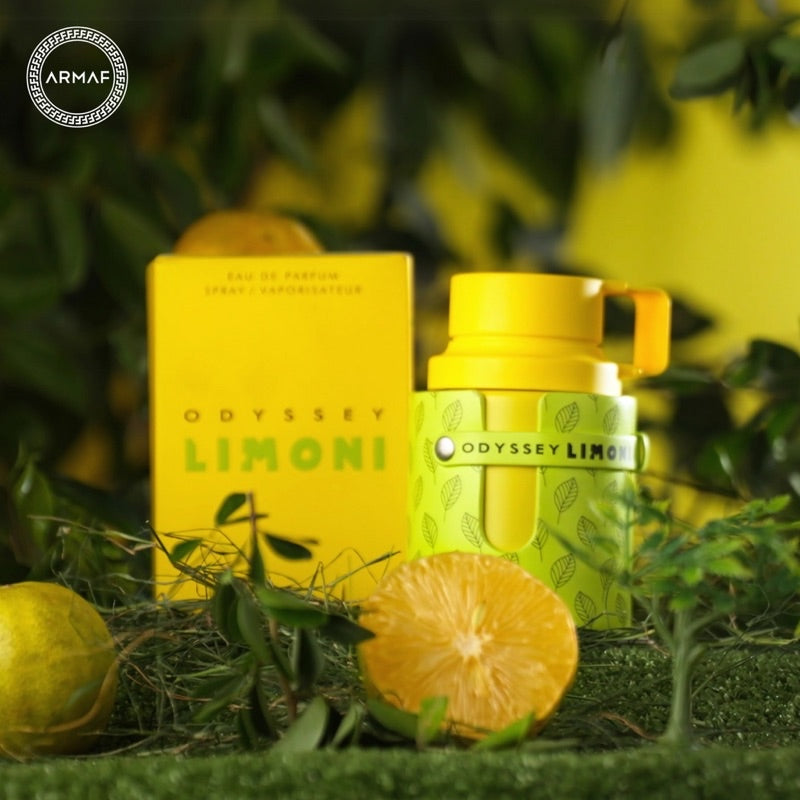 Odyssey Limoni perfume bottle and packaging with lemons and greenery on a blurred natural background